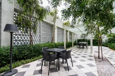 a courtyard with tables and chairs and trees at Una serviced Apartment in Kuala Lumpur