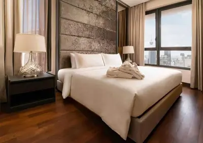 a bedroom with a large white bed and a large window at 8 Kia Peng KLCC by WSD in Kuala Lumpur