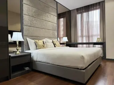 a bedroom with a large bed with a large headboard at 8 Kia Peng KLCC by WSD in Kuala Lumpur