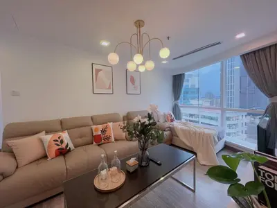 a living room with a couch and a large window at LUX SUITES KL City Pavilion Bukit Bintang with INFINITY POOL in Kuala Lumpur