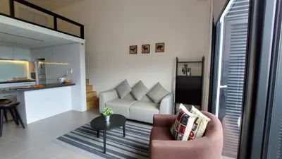 a living room with a couch and a table at KL Sentral Loft, EST Bangsar #8 in Kuala Lumpur