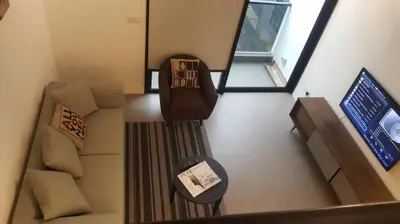 an overhead view of a living room with a couch and a television at KL Sentral Loft, EST Bangsar #8 in Kuala Lumpur