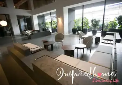 a lobby with tables and chairs in a building at KL Sentral Loft, EST Bangsar #8 in Kuala Lumpur