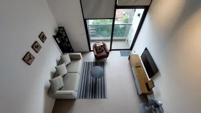 an overhead view of a living room with a couch and a tv at KL Sentral Loft, EST Bangsar #8 in Kuala Lumpur