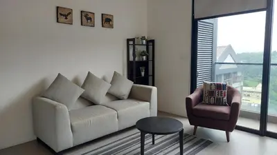 a living room with a couch and a chair at KL Sentral Loft, EST Bangsar #8 in Kuala Lumpur