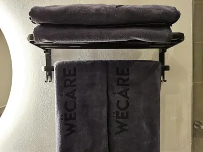 a group of towels on a rack in a bathroom at The Peak - Bangsar South Mid Valley in Kuala Lumpur