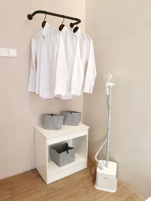 a rack of white shirts hanging on a wall at The Peak - Bangsar South Mid Valley in Kuala Lumpur