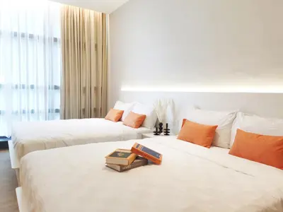 two beds with books on them in a hotel room at The Peak - Bangsar South Mid Valley in Kuala Lumpur