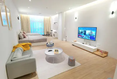 a living room with a couch and a flat screen tv at The President - Bangsar South Mid Valley in Kuala Lumpur