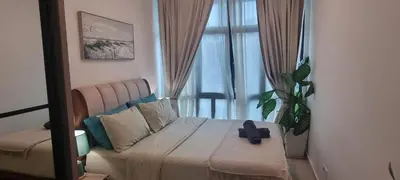 a bedroom with a large bed and a mirror at Aldridge Residence Coastal KLCC in Kuala Lumpur