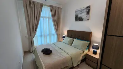 a bedroom with a bed and a large window at Aldridge Residence Coastal KLCC in Kuala Lumpur