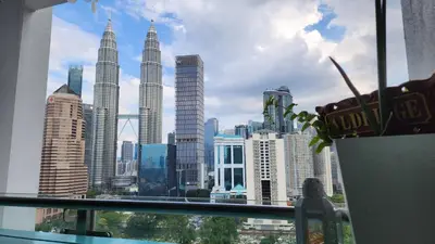 a view of a city skyline from a window at Aldridge Residence Coastal KLCC in Kuala Lumpur