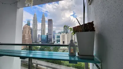a window with a view of a city skyline at Aldridge Residence Coastal KLCC in Kuala Lumpur