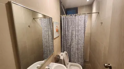a small bathroom with a toilet and a shower at Aldridge Residence Coastal KLCC in Kuala Lumpur