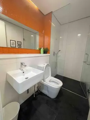 a bathroom with a sink and a toilet and a mirror at New Arcoris Mont Kiara Huge Balcony for 8 pax 2 BR -Garden- in Kuala Lumpur