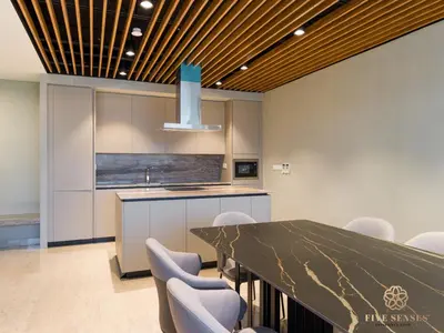 a kitchen with a long table and chairs at Datum Jelatek Sky Residence KLCC, Five Senses in Kuala Lumpur