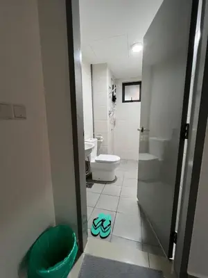 a bathroom with a toilet and a sink and a door at Dsistyle Islamic House in Kuala Lumpur