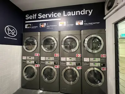 a row of washing machines in a laundry room at Dsistyle Islamic House in Kuala Lumpur