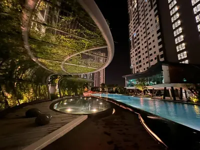 a swimming pool in a city at night at Dsistyle Islamic House in Kuala Lumpur