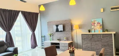 a living room with a dining room table and a living room at Regalia Suites KLCC View Rooftop Infinity Pool by SHI in Kuala Lumpur