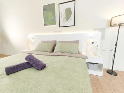 a bedroom with a bed with a purple pillow on it at Panoramic City - Bangsar South Mid Valley in Kuala Lumpur