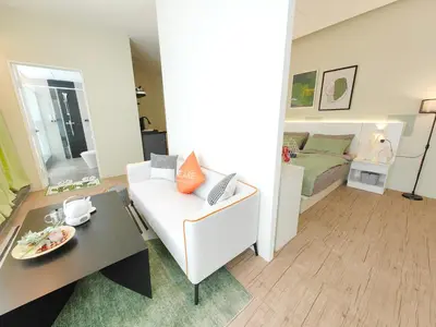 a living room with a white couch and a bed at Panoramic City - Bangsar South Mid Valley in Kuala Lumpur