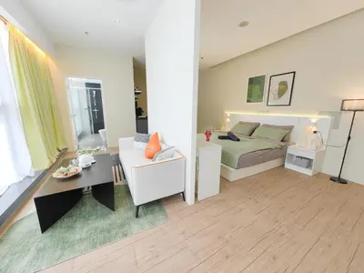a bedroom with a bed and a desk and a couch at Panoramic City - Bangsar South Mid Valley in Kuala Lumpur