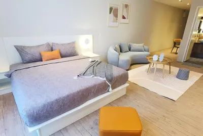 a bedroom with a bed and a chair and a table at BTC The Curvena Bangsar South Mid Valley in Kuala Lumpur