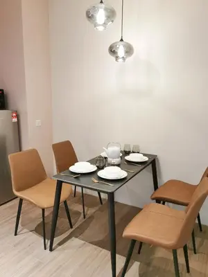 a black table with chairs and plates on it at BTC The Curvena Bangsar South Mid Valley in Kuala Lumpur