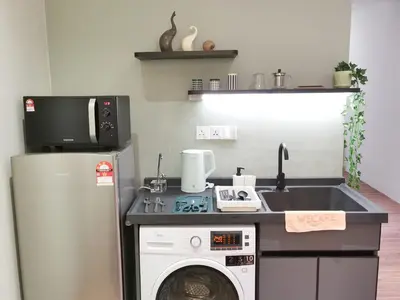 a kitchen with a sink and a washing machine at BTC The Curvena Bangsar South Mid Valley in Kuala Lumpur