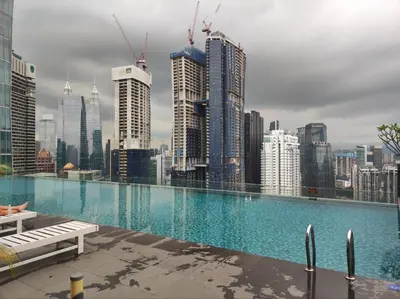 a large swimming pool on top of a city skyline at Dorsett Residence KL Private Studio apartment in Kuala Lumpur