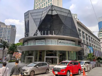 a large building with cars parked in front of it at Dorsett Residence KL Private Studio apartment in Kuala Lumpur