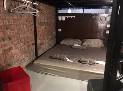 a room with a bed in a brick wall at OA ThE FACTORY AT BUKIT BINTANG in Kuala Lumpur
