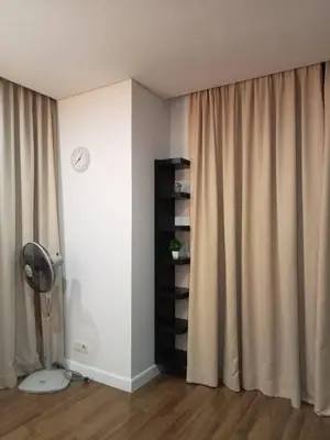 a room with a fan and a window with curtains at ESTELAR Apartments at Mercu Summer KLCC in Kuala Lumpur