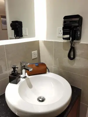 a bathroom with a sink and a phone on the wall at The Toorak @ Bangsar South Mid Valley in Kuala Lumpur