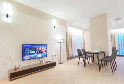 a living room with a table and a flat screen tv at The Toorak @ Bangsar South Mid Valley in Kuala Lumpur