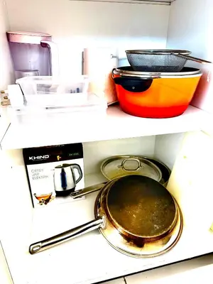 two shelves of a kitchen with pots and pans at The Robertson 2B at Bukit Bintang with Netflix,trx,klcc,pavilion,lalaport in Kuala Lumpur