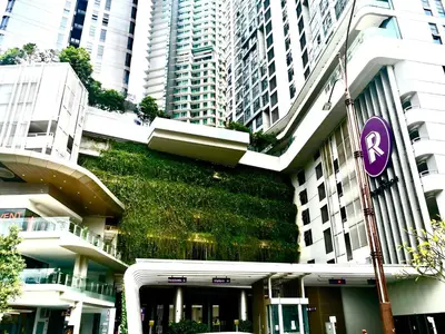 a building with a green wall on the side of it at The Robertson 2B at Bukit Bintang with Netflix,trx,klcc,pavilion,lalaport in Kuala Lumpur