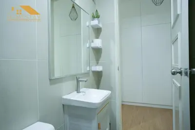 a white bathroom with a sink and a mirror at Legasi Kampung Baru by Twenty7 in Kuala Lumpur