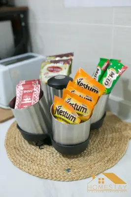 a counter top with three containers filled with food at Legasi Kampung Baru by Twenty7 in Kuala Lumpur