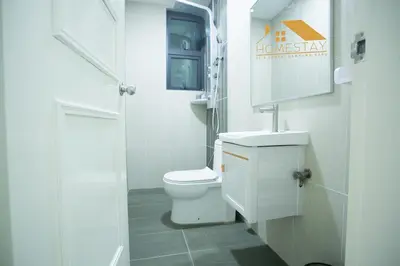 a white bathroom with a toilet and a sink at Legasi Kampung Baru by Twenty7 in Kuala Lumpur