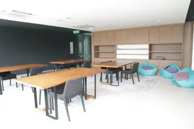 a dining room with wooden tables and blue chairs at MyCrib45*The Robertson KL-B.Bintang in Kuala Lumpur
