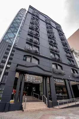 a tall black building with stairs in front of it at Hotel 28 Chow Kit Kuala Lumpur in Kuala Lumpur