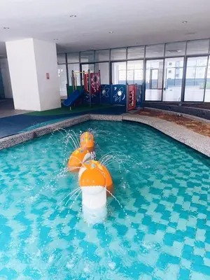 a swimming pool with an orange life preserver in the water at Connected train 3 Bedrooms - ABOVE KLGATEWAY MALL 14 in Kuala Lumpur