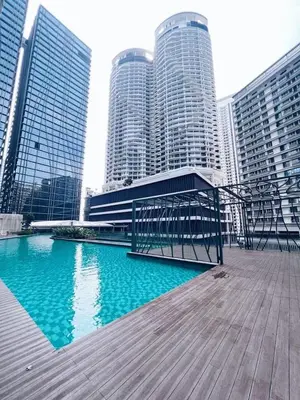 a boardwalk in front of a city with tall buildings at Connected train 1 Bedroom ABOVE MALL-16 in Kuala Lumpur