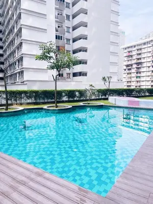 a large blue swimming pool in a city with buildings at Connected train 1 Bedroom ABOVE MALL-16 in Kuala Lumpur