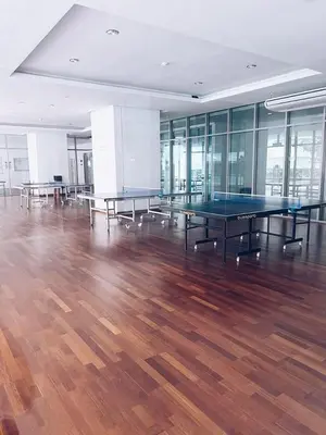 a room with ping pong tables on a wooden floor at Connected train 1 Bedroom ABOVE MALL-16 in Kuala Lumpur