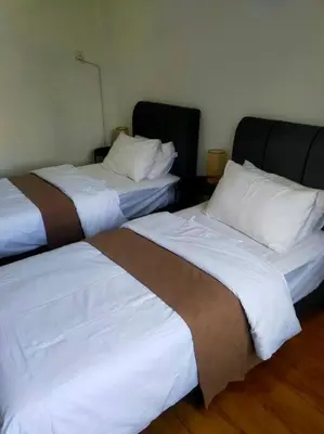 two beds sitting next to each other in a room at Omar's place 4 - Best view of KLCC Twin Towers. in Kuala Lumpur