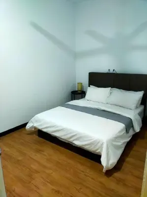 a bedroom with a large bed with white sheets and pillows at Omar's place 4 - Best view of KLCC Twin Towers. in Kuala Lumpur