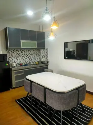 a kitchen with a white table and some chairs at Omar's place 4 - Best view of KLCC Twin Towers. in Kuala Lumpur
